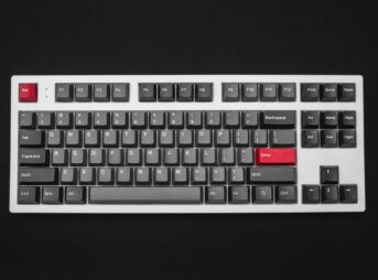 a black and white keyboard with red keys