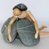 wooden figure, stones, struggle for life