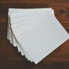 White Ruled Paper Lot on Brown Wooden Surface