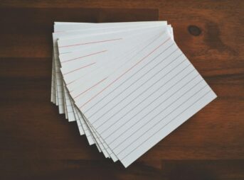 White Ruled Paper Lot on Brown Wooden Surface